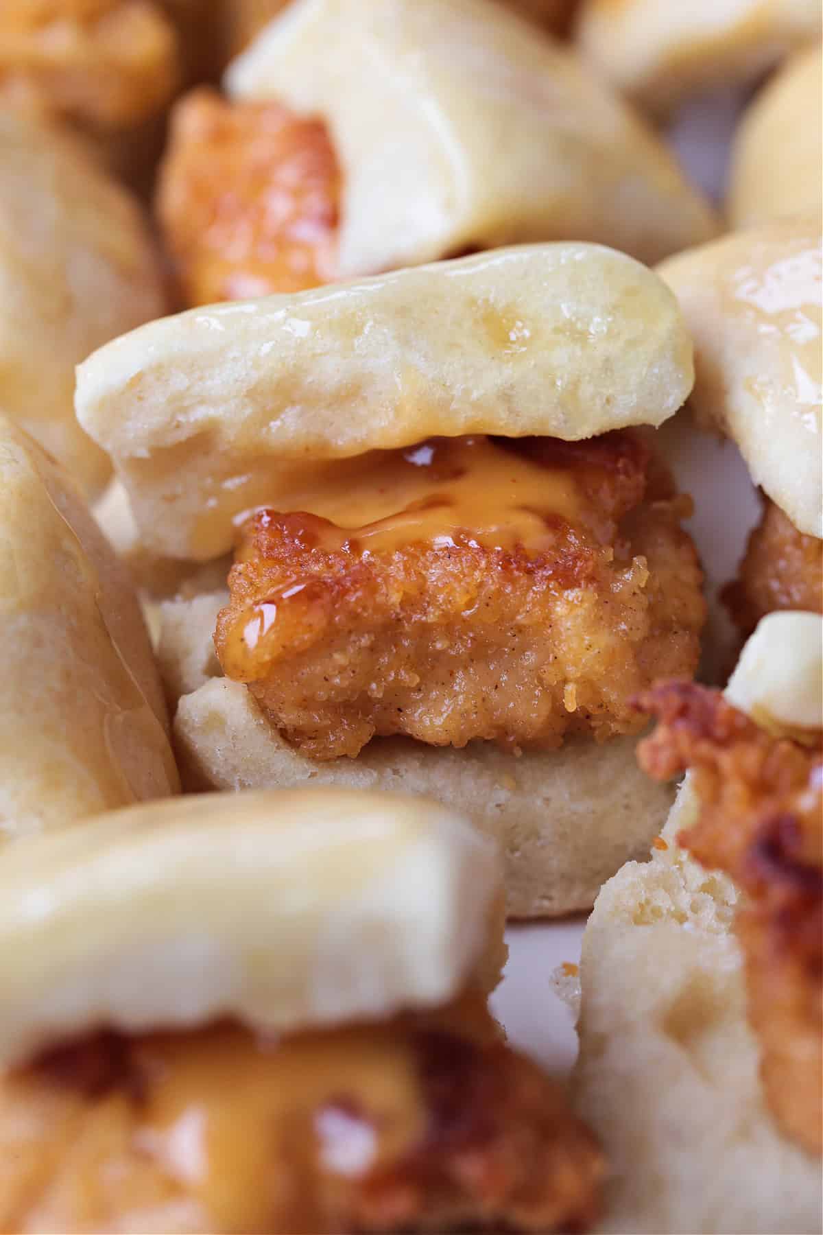 Make these Copycat Chicken Minis for your next party or game day! Just like the Chick Fil A version only better because they're homemade! mini chicken sliders with chick fil a sauce on platter