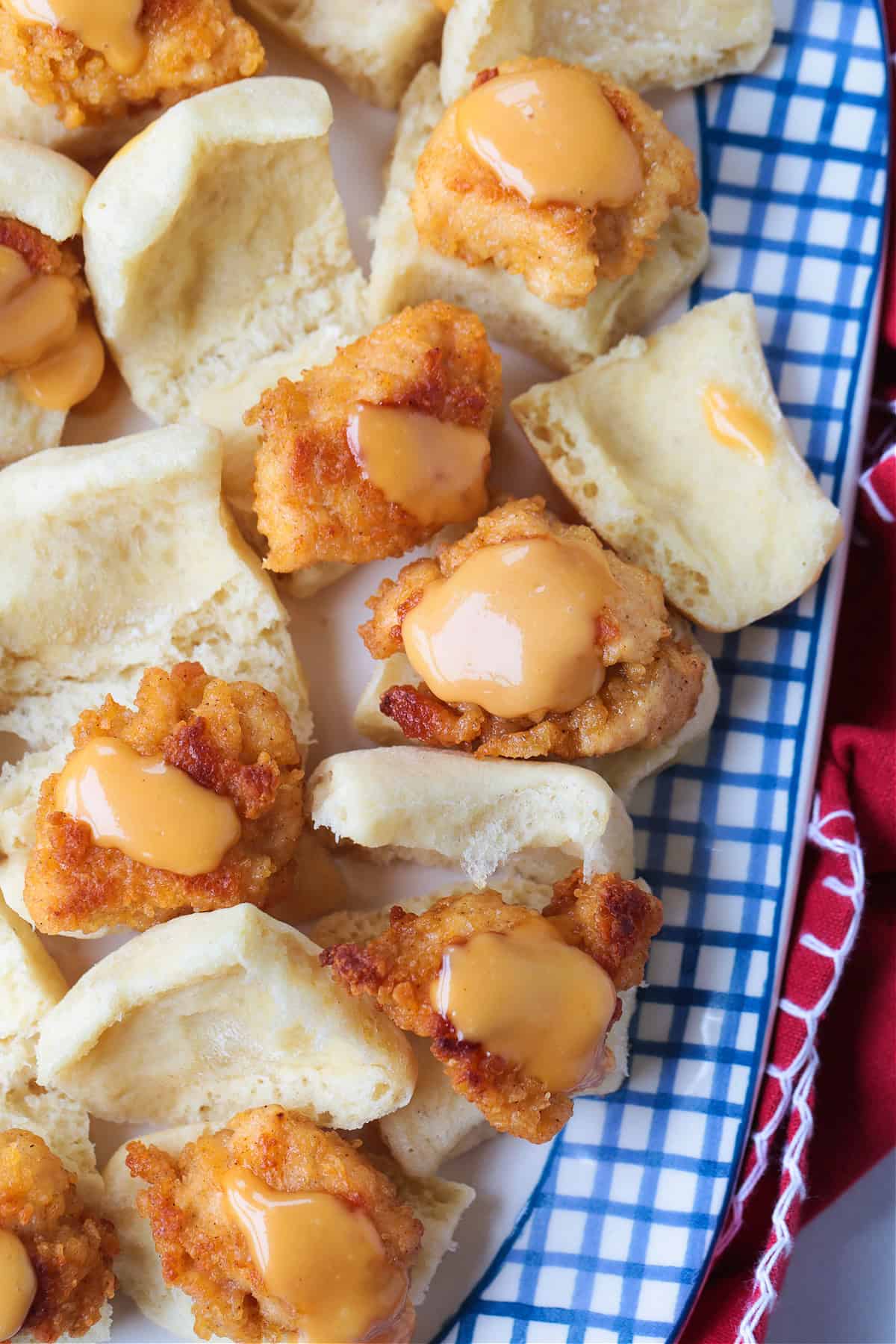 Make these Copycat Chicken Minis for your next party or game day! Just like the Chick Fil A version only better because they're homemade! platter of mini chicken sandwiches with sauce