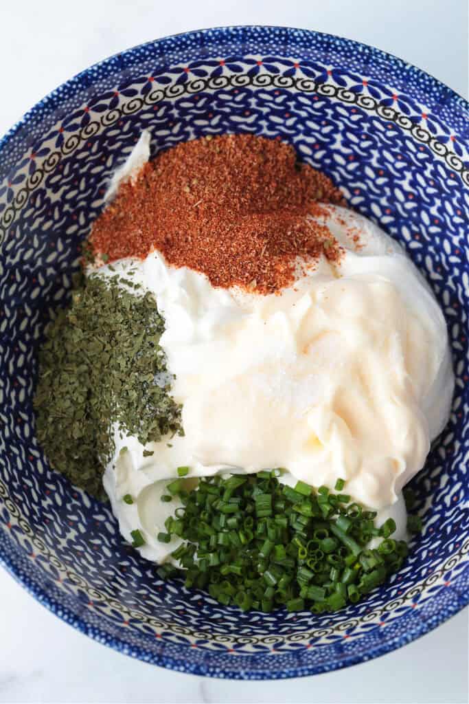 This Sour Cream Dip is a party appetizer staple! Perfect for dipping chips, pretzels and veggies, everyone will be asking for the recipe! ingredients in bowl for making dip recipe