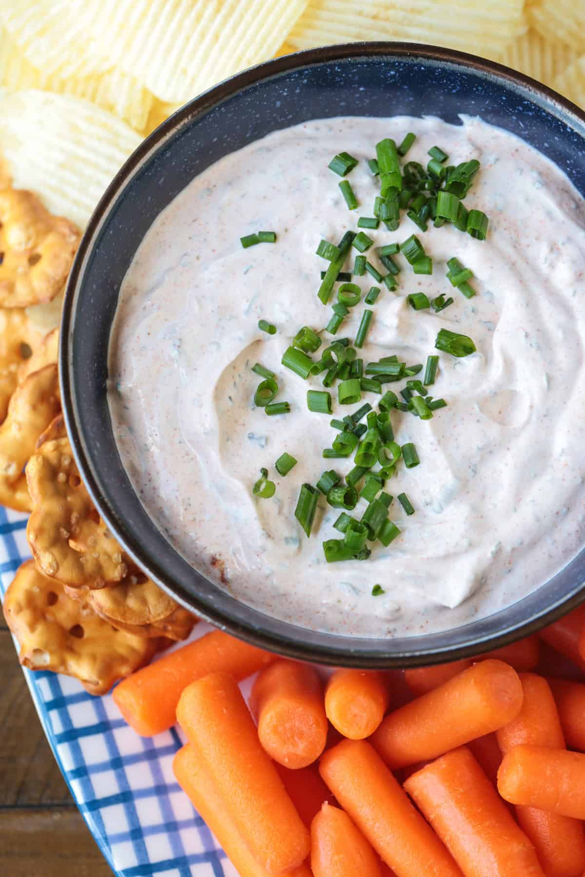 This Sour Cream Dip is a party appetizer staple! Perfect for dipping chips, pretzels and veggies, everyone will be asking for the recipe! dip in bowl with chives on top