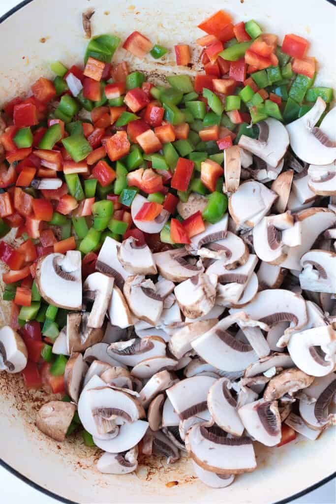 This Italian Breakfast Casserole is delicious for brunch or dinner with a salad! We love this cozy and hearty casserole any time of the day! peppers and mushrooms in skillet