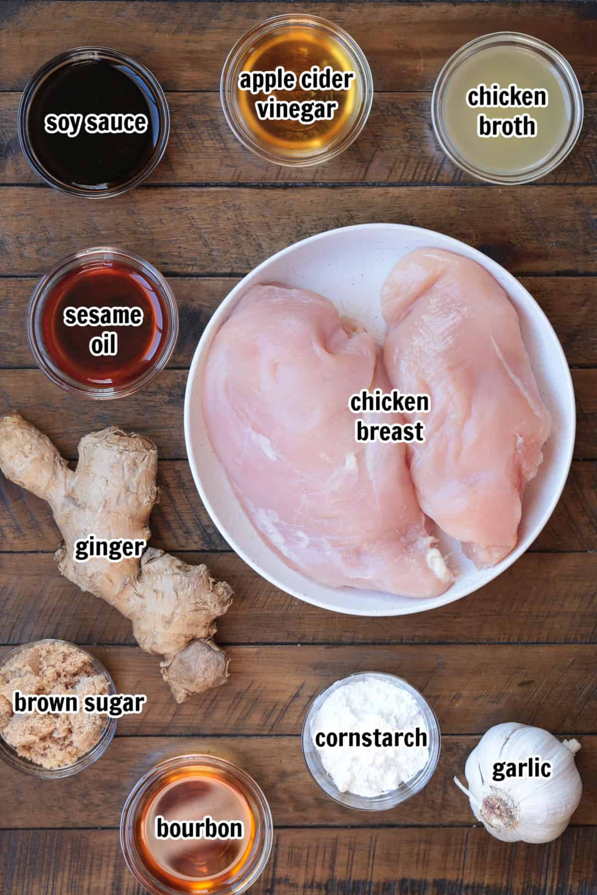 Our Easy Bourbon Chicken is a family favorite dinner recipe! Tender chicken in a sweet and tangy sauce with just a splash of bourbon. ingredients on a board with text for chicken recipe