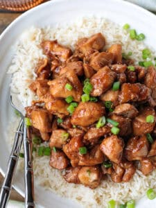 bourbon chicken with scallions over a bed of rice