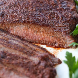 close up of sliced flank steak on platter