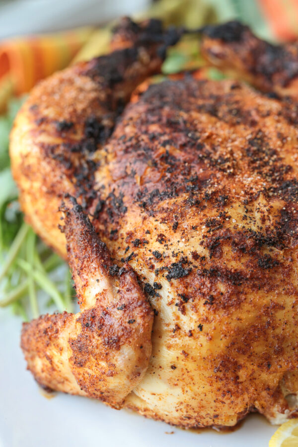 rotisserie chicken on platter with parsley