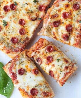 french bread pizza sliced on a white platter