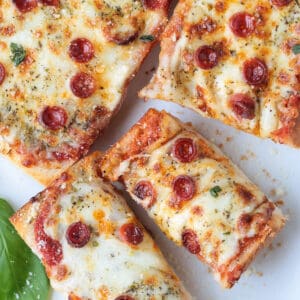 french bread pizza sliced on a white platter