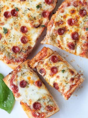 french bread pizza sliced on a white platter