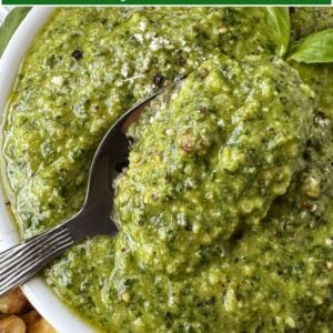 spoonful of pesto in bowl with text overlay for pinterest