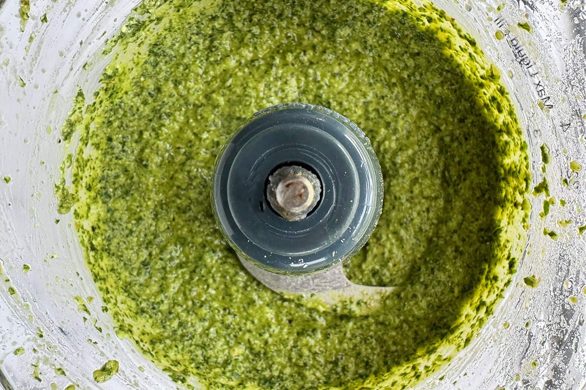 Make this tasty basil walnut pesto with just a few simple ingredients. A quick, vibrant sauce for chicken, fish or steak and so much more! basil pesto in a food processor