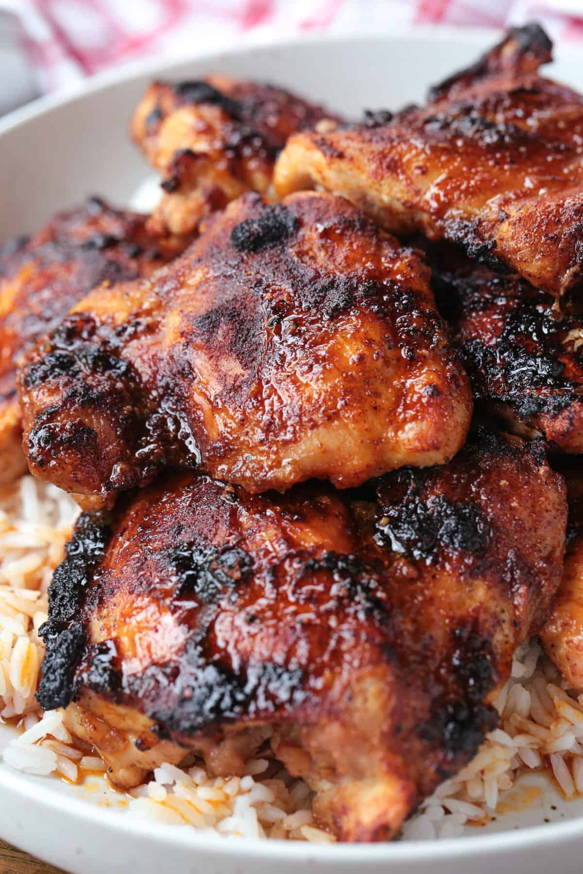 broiled chicken on a plate with rice