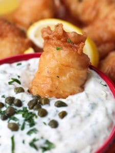fried fish dipped into tartar sauce
