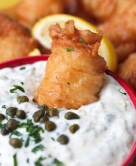 fried fish dipped into tartar sauce