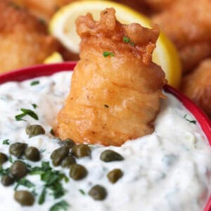 fried fish dipped into tartar sauce