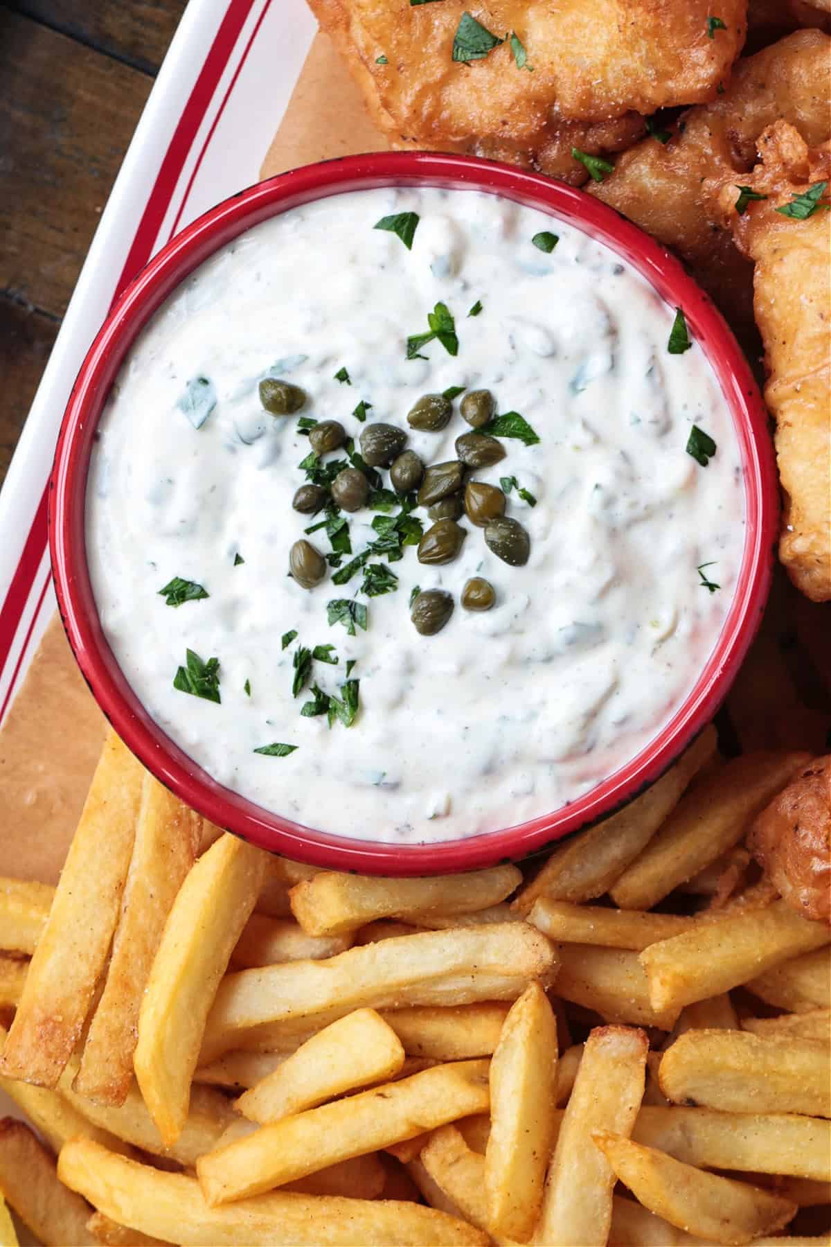 Easy homemade tartar sauce is creamy, tangy, and packed with fresh flavor. Delicious on fish, shrimp, fries, and so munch more! tartar sauce in red bowl with capers