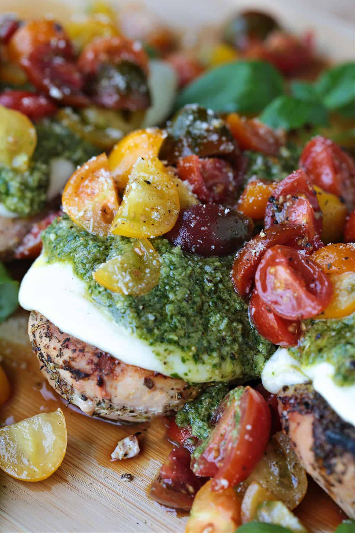Grilled Chicken Margherita is an easy dinner recipe made with juicy grilled chicken, fresh mozzarella, ripe tomatoes, garlic, and pesto. grilled chicken breasts with pesto, cheese and tomato topping