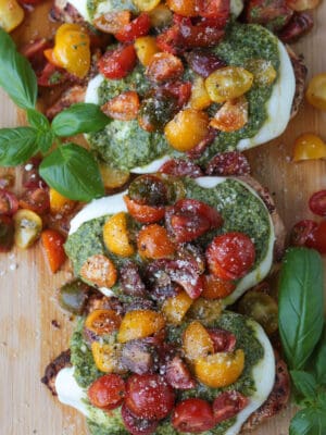 chicken margherita on a board with basil