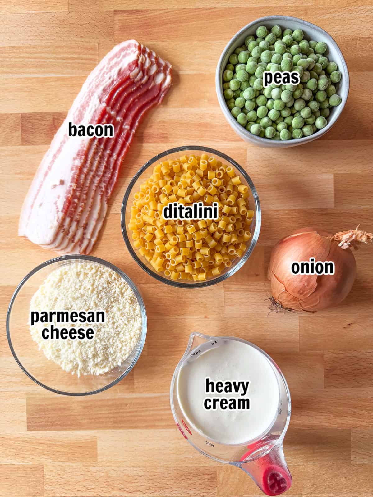 This creamy Bacon and Pea Ditalini pasta can be served as a side dish to dinner or as a meal on its own. Ready in 30 and sure to please! ingredients for making a pasta recipe with bacon and peas