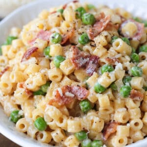 ditalini with bacon and peas in bowl from the side