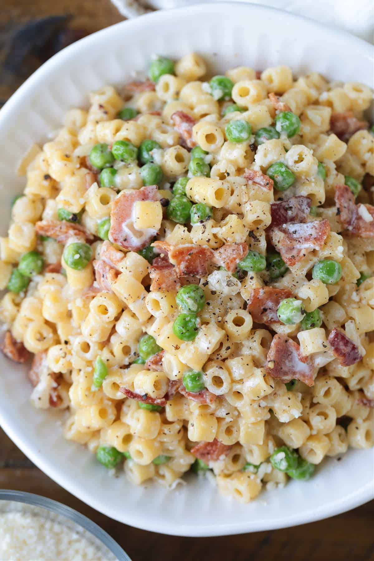 This creamy Bacon and Pea Ditalini pasta can be served as a side dish to dinner or as a meal on its own. Ready in 30 and sure to please! ditalini pasta with peas and bacon in white bowl