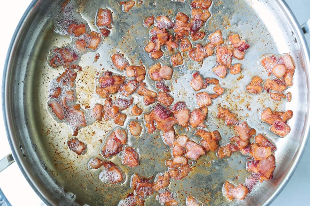 This creamy Bacon and Pea Ditalini pasta can be served as a side dish to dinner or as a meal on its own. Ready in 30 and sure to please! cooked, diced bacon in a skillet