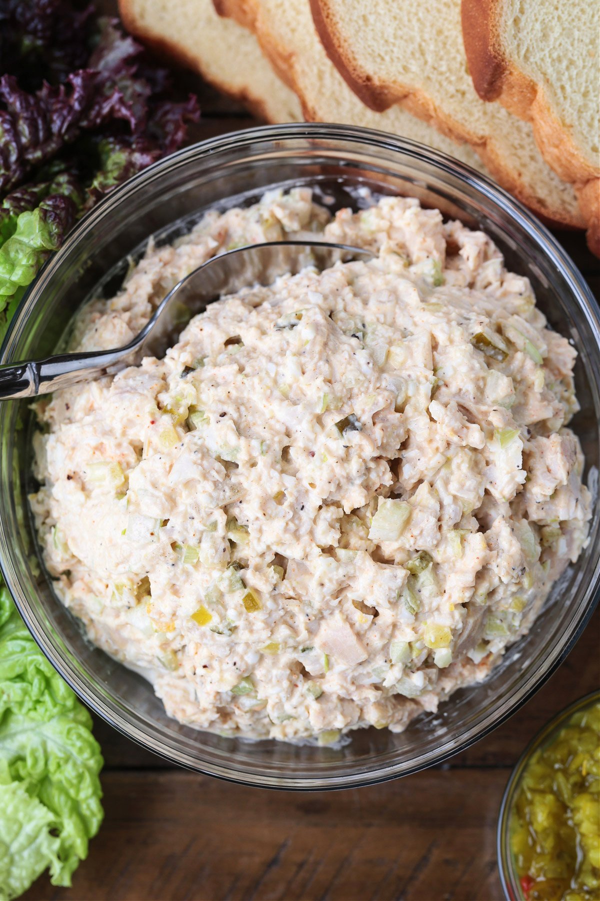 chicken salad in a glass bowl with spoon