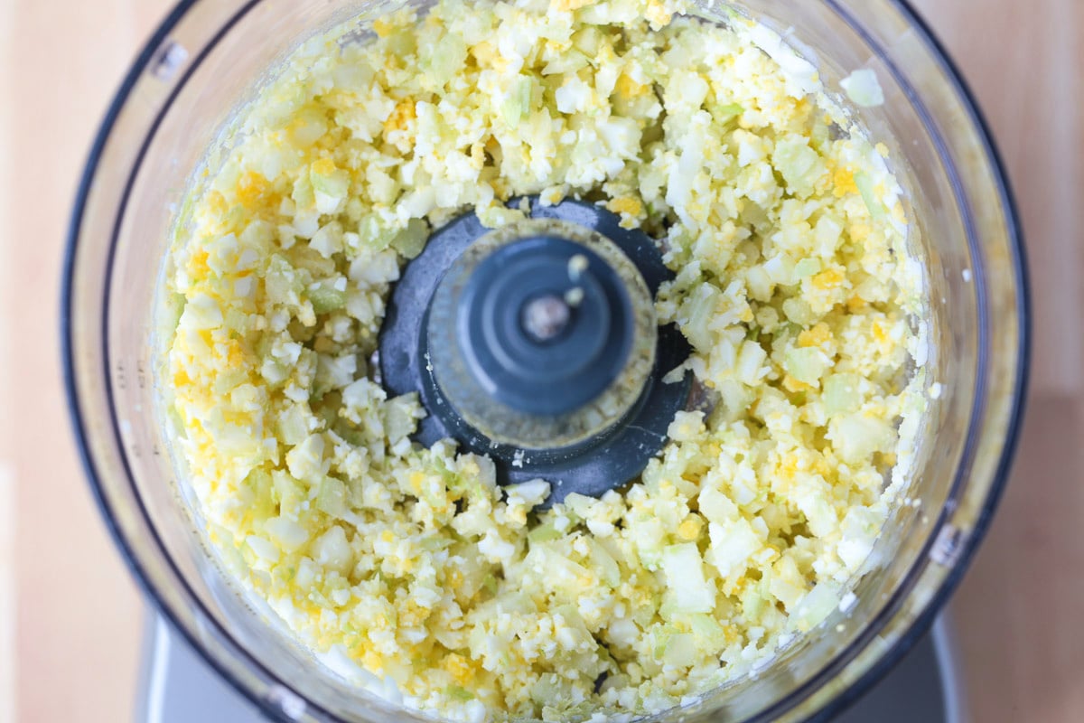 hard boiled eggs and celery in a food processor chopped up