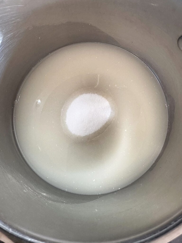 This homemade coconut sorbet is bursting with tropical flavor! Made with coconut milk and simple ingredients for a refreshing summer dessert. sugar and water in pot