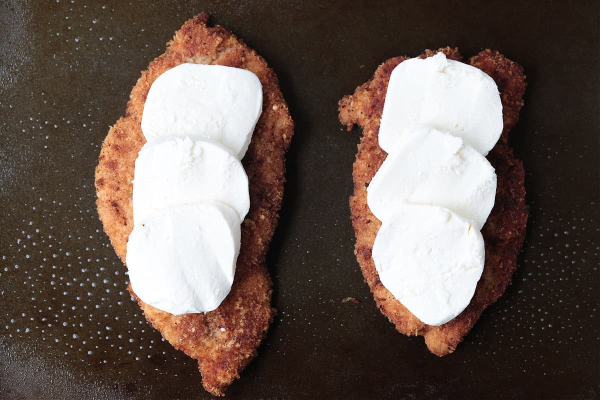 Super crispy chicken parmesan, not made soggy form baking in sauce. Serve over pasta or on a plate with marinara for the ultimate crispiness! chicken cutlets with slices of fresh mozzarella