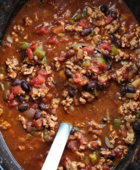 turkey chili in a slow cooker with ladle