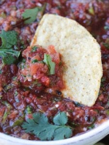 chip dipped in bowl of salsa