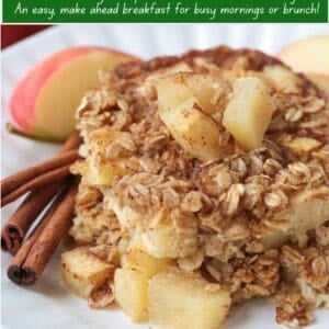 baked oatmeal with apples stacked on plate with cinnamon sticks