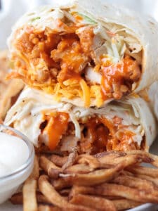 chicken wrap with buffalo sauce, coleslaw and cheese cut in half and stacked