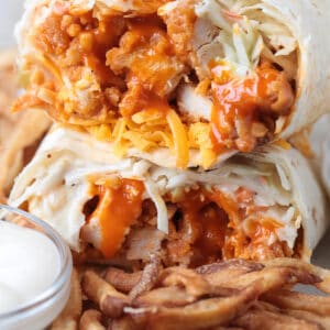 chicken wrap with buffalo sauce, coleslaw and cheese cut in half and stacked
