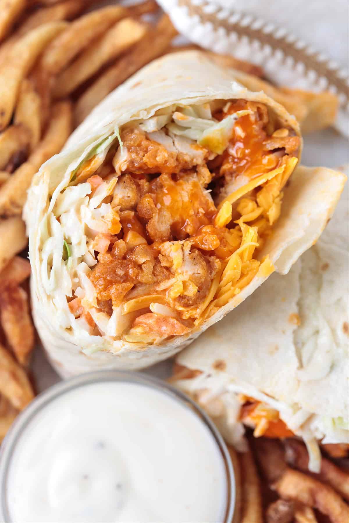 buffalo chicken wrap cut in half and stacked with french fries