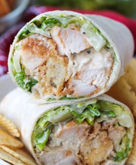 chicken caesar wrap cut and stacked on a plate
