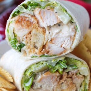 chicken caesar wrap cut and stacked on a plate