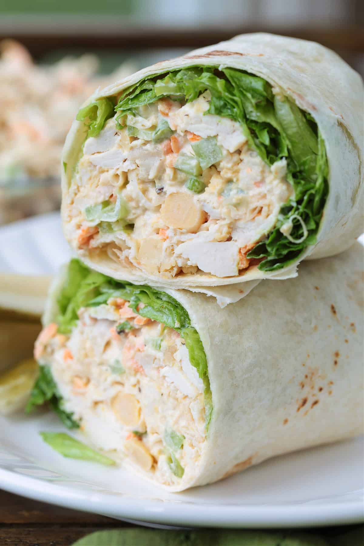 Chickpea Chicken Salad is made with tender chicken, crunchy veggies and buttery chickpeas. A protein packed meal that's ready in minutes! chicken salad with chickpeas in a wrap with lettuce