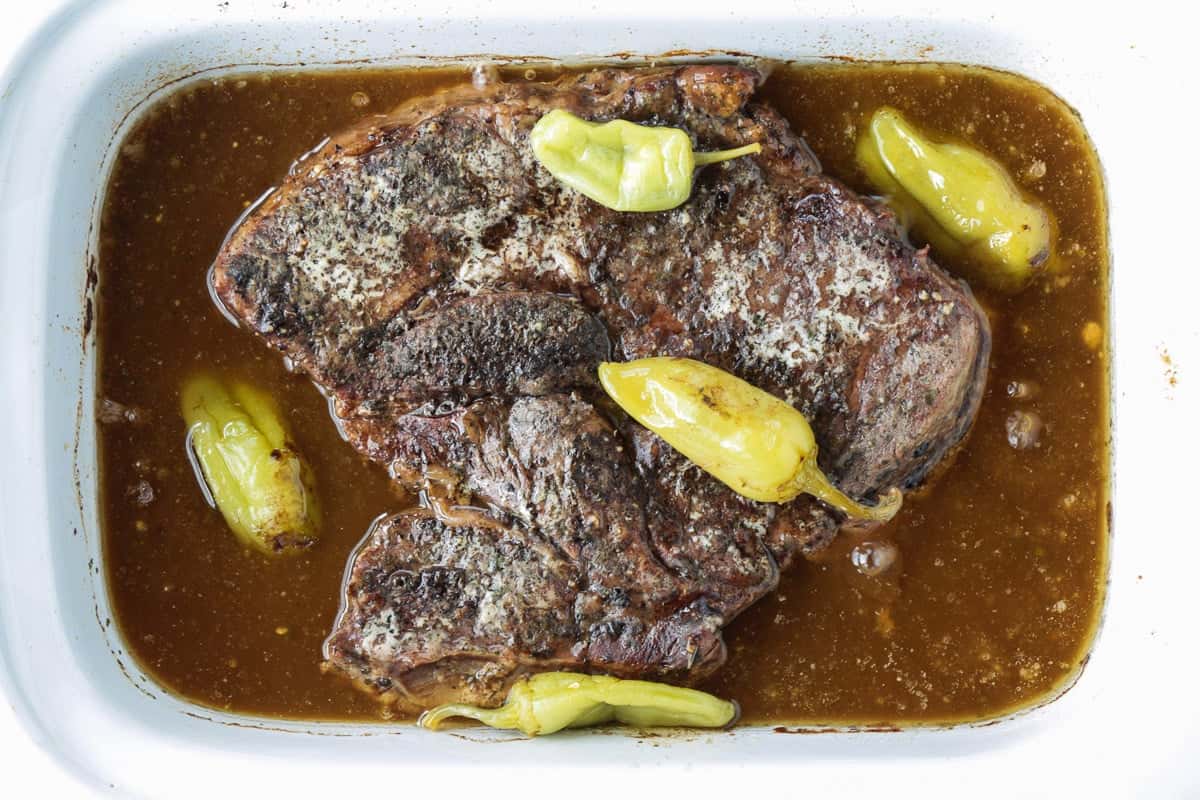 Slow Cooker Mississippi Pot Roast is tender and delicious in a tangy brown gravy. An easy crock pot dinner the whole family will love! pot roast in slow cooker with peppers
