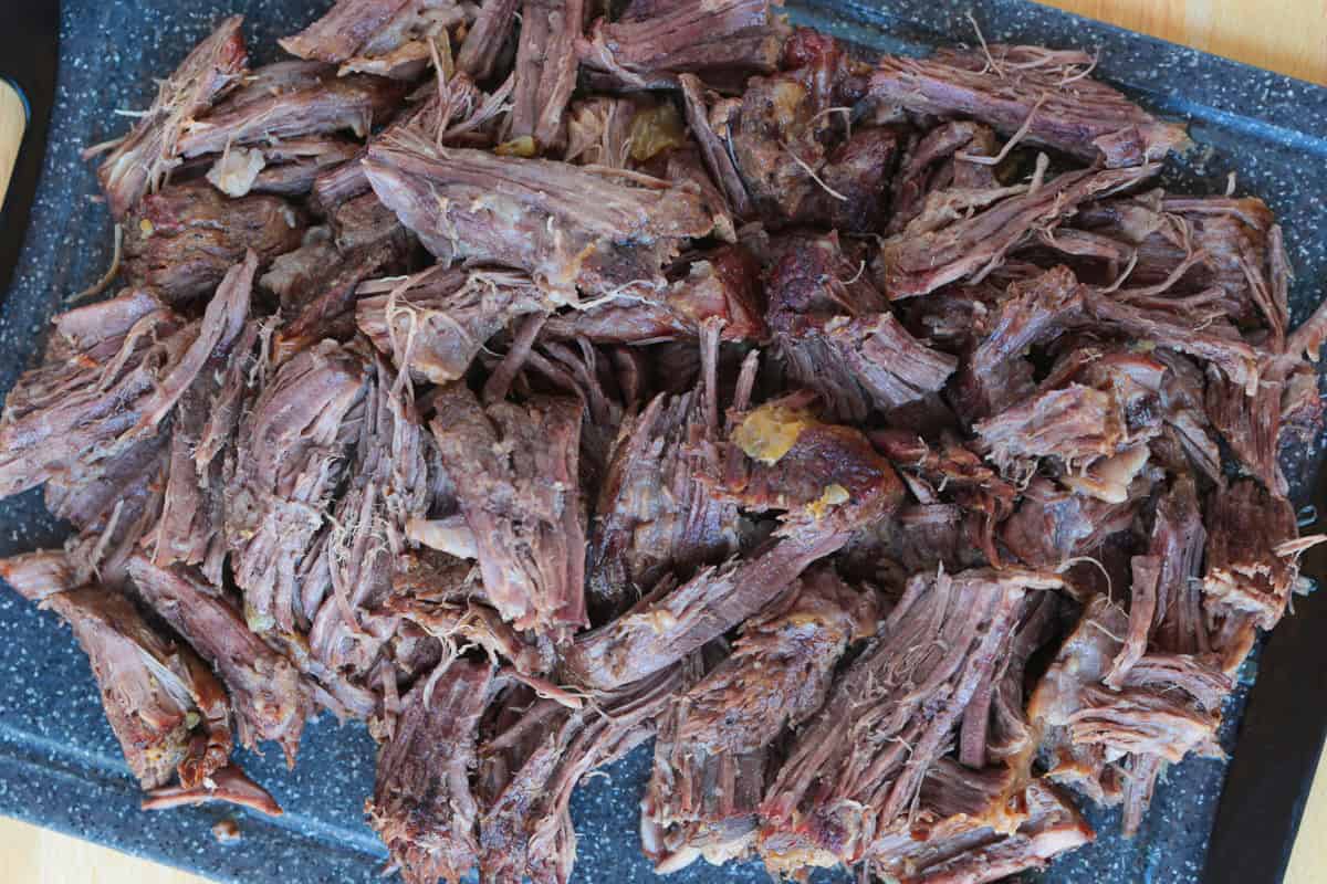 shredded pot roast on cutting board