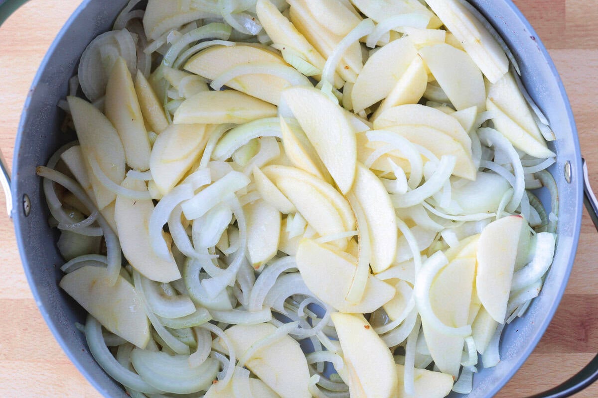sliced apples and onions in pot