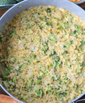 cheesy broccoli orzo in a pot from the top view