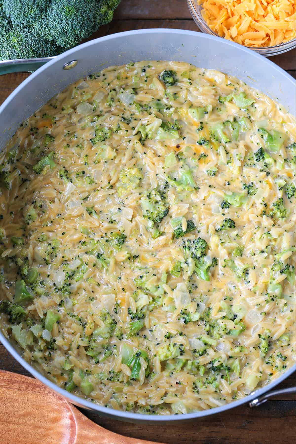 This Cheesy Broccoli Orzo is the ultimate comfort food side dish! Perfect alongside chicken or steak, or on its own for an easy, cozy dinner. cheesy broccoli orzo in a pot from the top view
