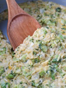up close scoop of broccoli cheddar orzo