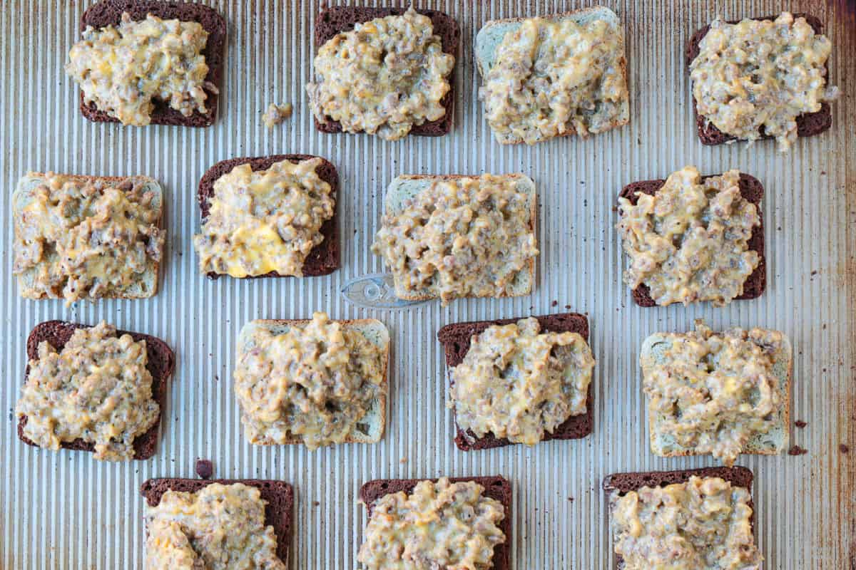 cocktail rye bread with a toppings of ground beef, sausage and Velveeta