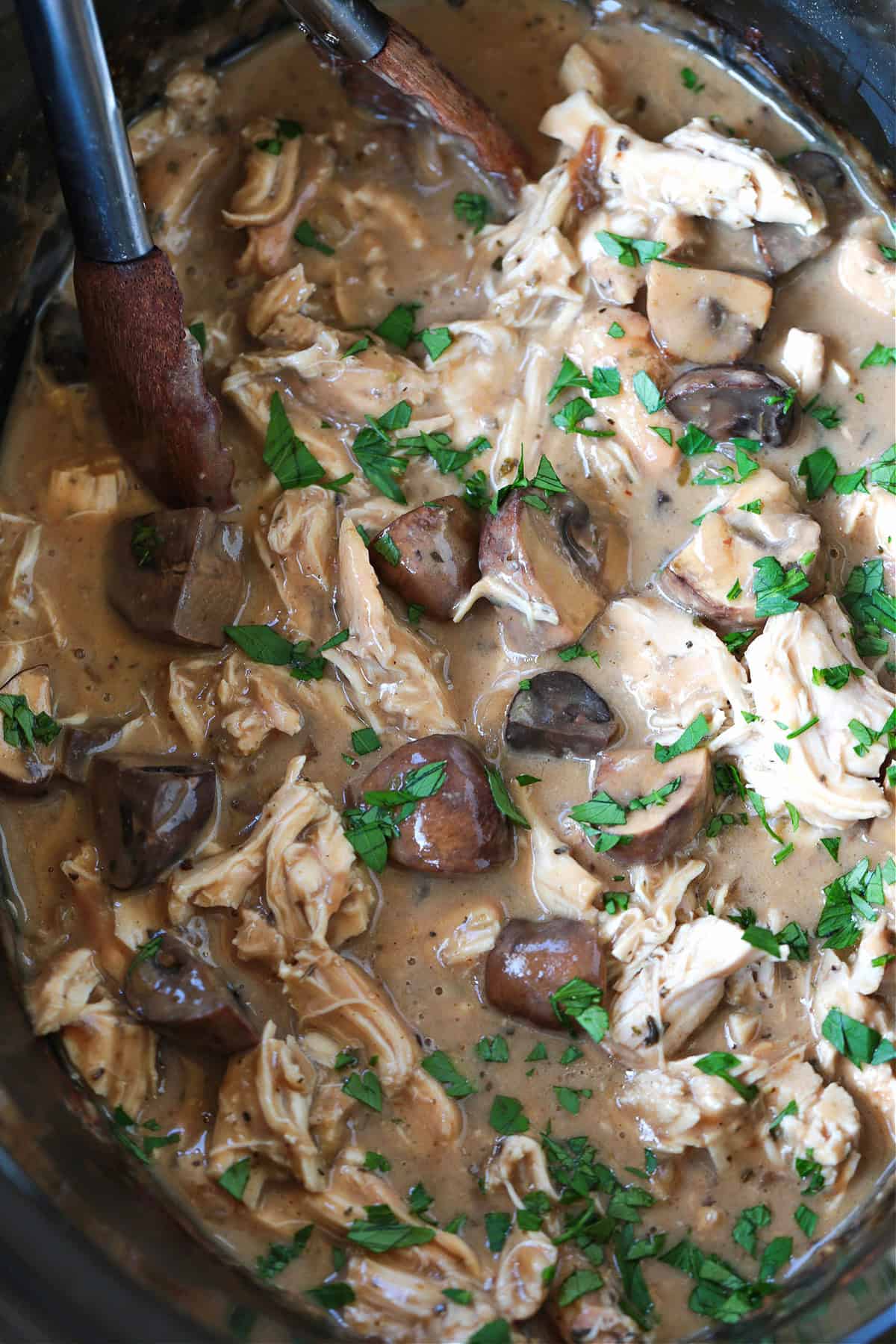 This cozy Slow Cooker Chicken Stroganoff is creamy and hearty, we love it for busy weeknights or lazy weekends. An easy comfort food dinner! crock pot chicken stroganoff with tongs