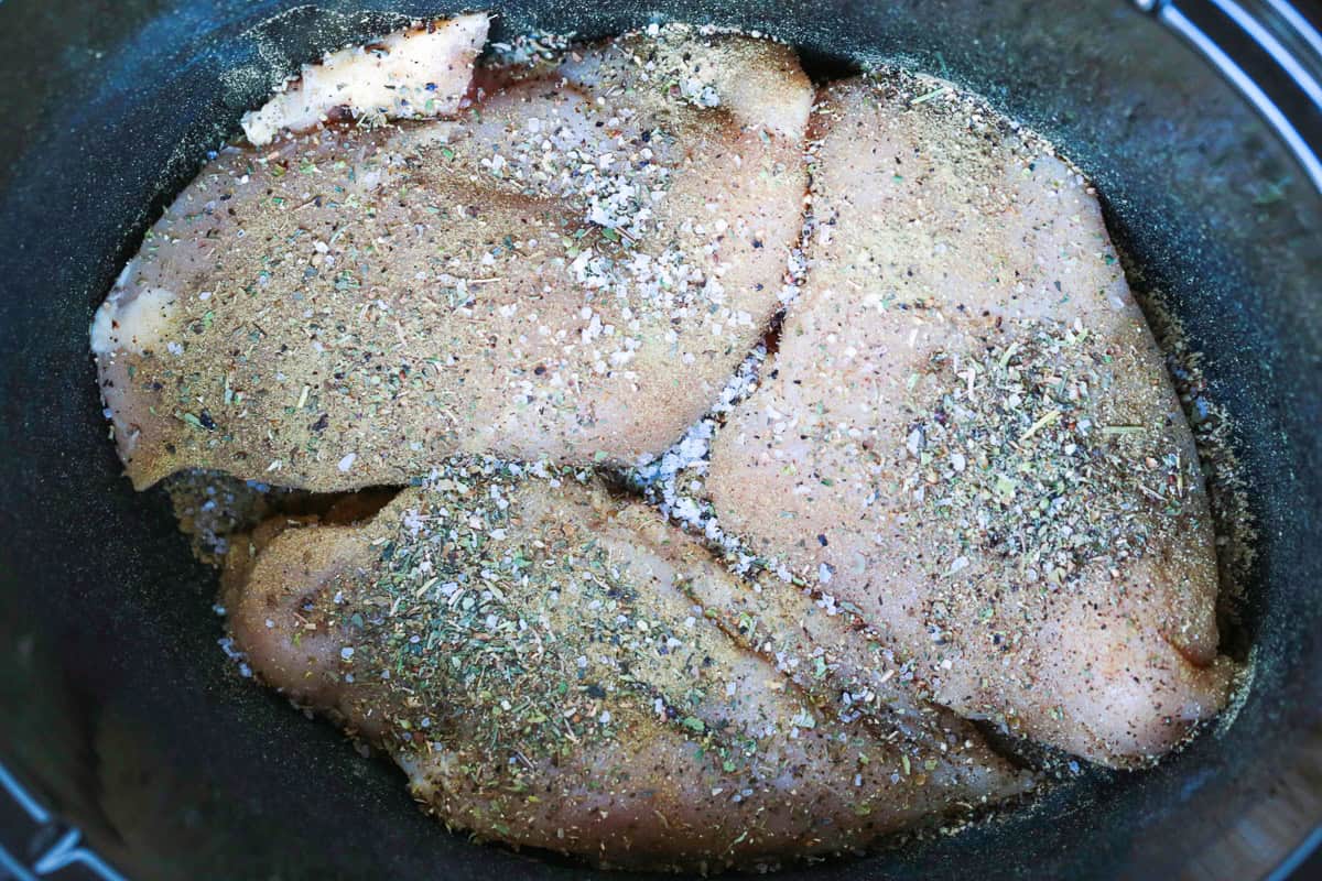 This cozy Slow Cooker Chicken Stroganoff is creamy and hearty, we love it for busy weeknights or lazy weekends. An easy comfort food dinner! seasoned chicken breasts in a crock pot