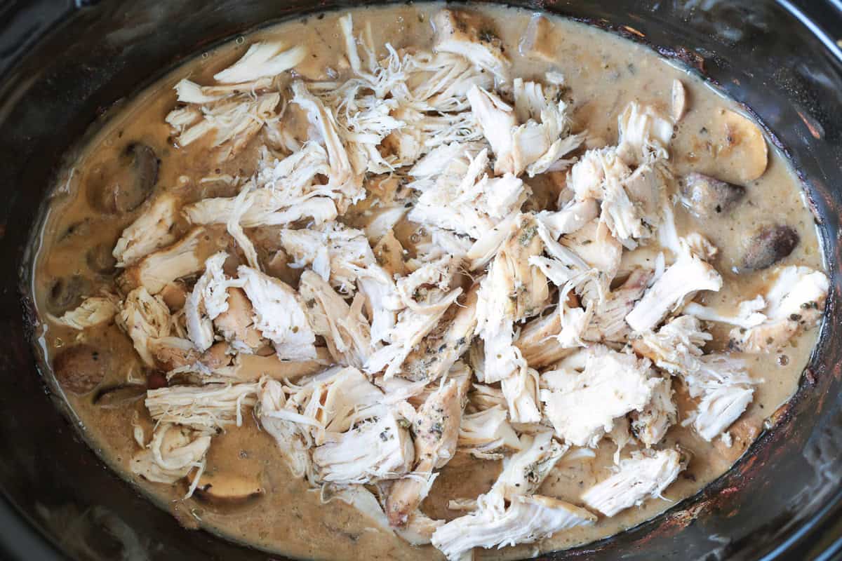 This cozy Slow Cooker Chicken Stroganoff is creamy and hearty, we love it for busy weeknights or lazy weekends. An easy comfort food dinner! shredded chicken in gravy in a slow cooker