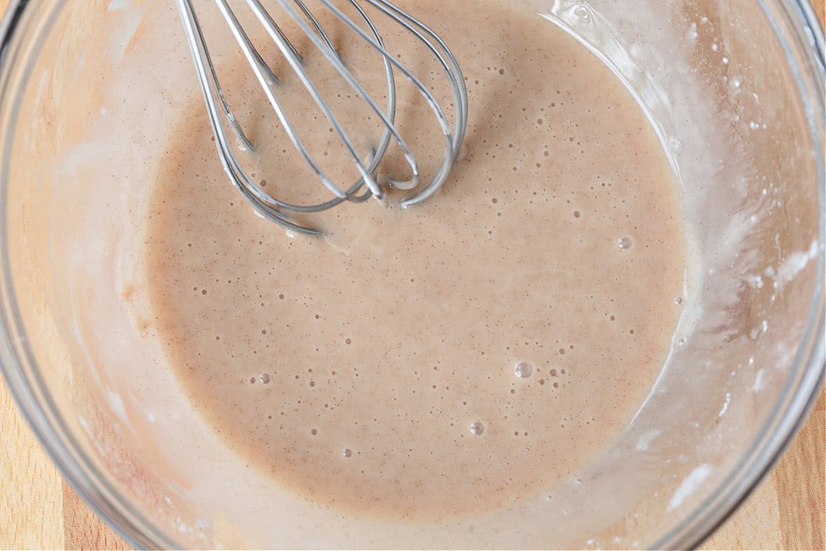 cinnamon icing in bowl with whisk