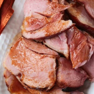 close up of sliced ham with glaze on a platter